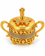 Ornate gold sugar bowl with lid and decorative handles on white background