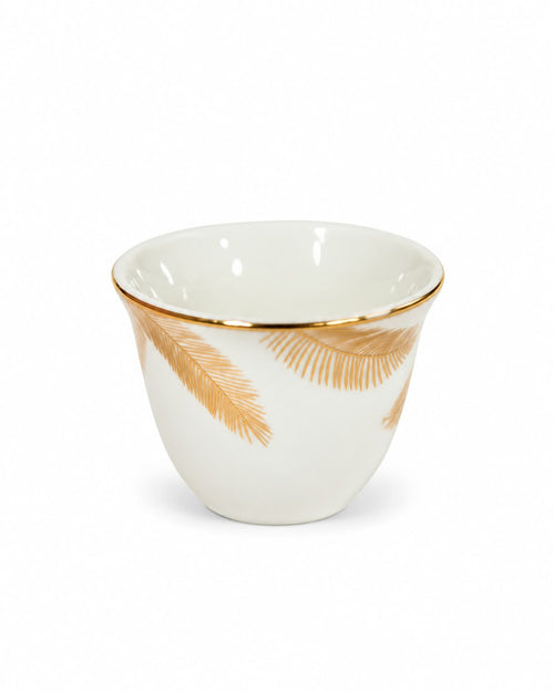 White and gold leaf coffee cup close-up
