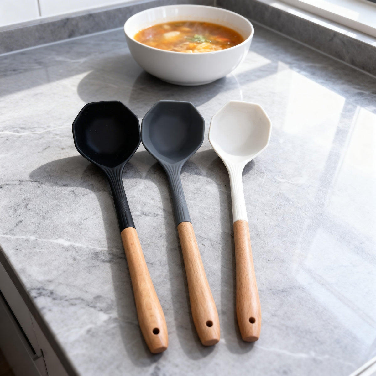 Trendy Shop set of three silicone soup ladles in black, grey, and white with ergonomic wooden handles.