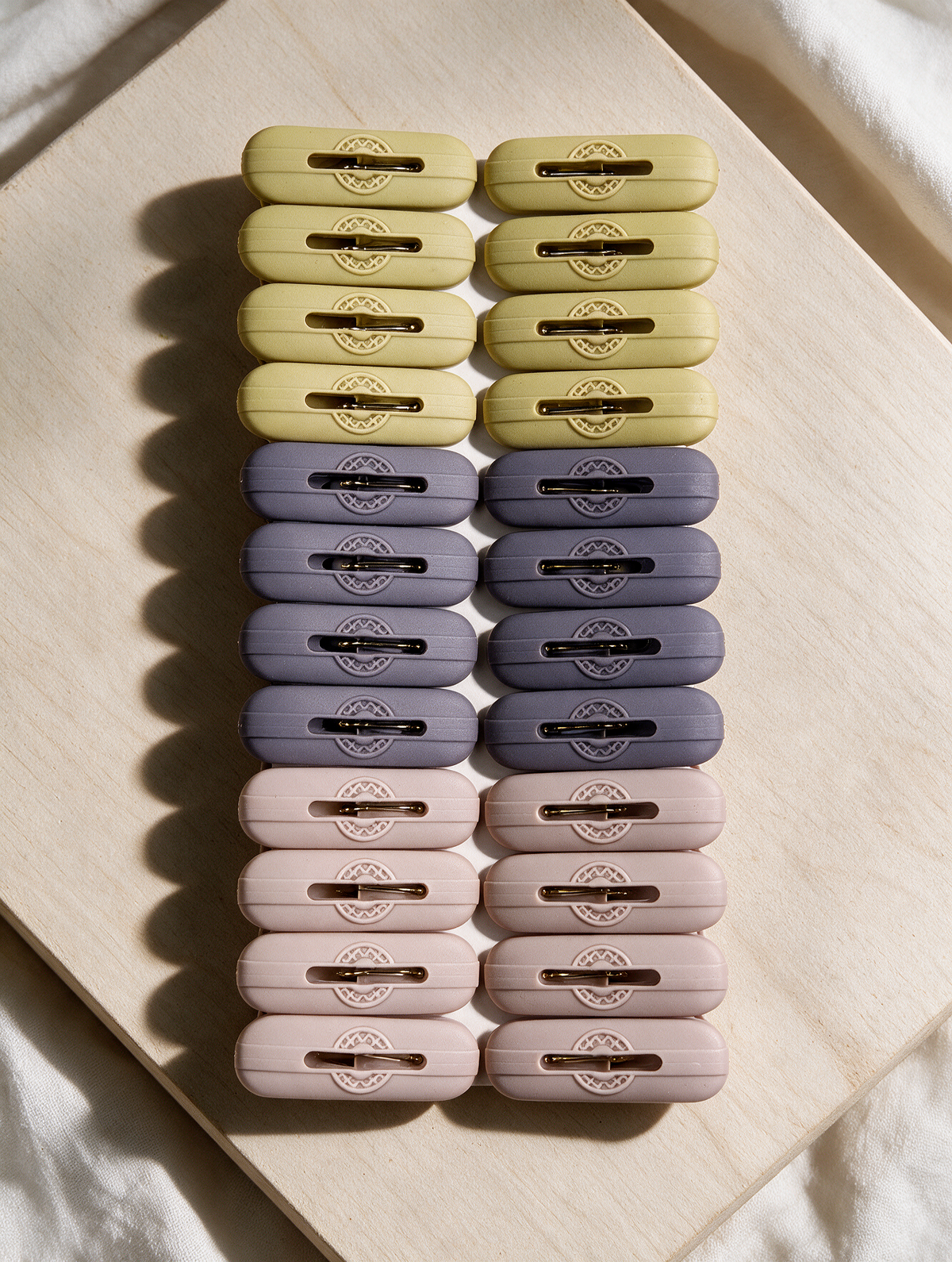 24-piece round-detail laundry clothes peg set arranged in a lifestyle scene