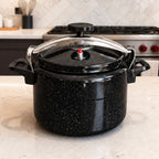 Vallena 12-liter pressure cooker in black granite finish with a secure metal clamping lid on a kitchen countertop.
