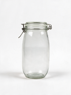 Clear clip-top glass storage jar on a white background