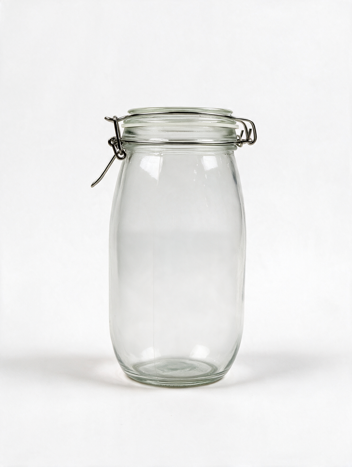 Clear clip-top glass storage jar on a white background