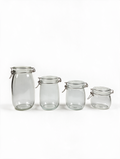Clip-top glass storage jars in four sizes on a white background