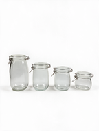 Clip-top glass storage jars in four sizes on a white background