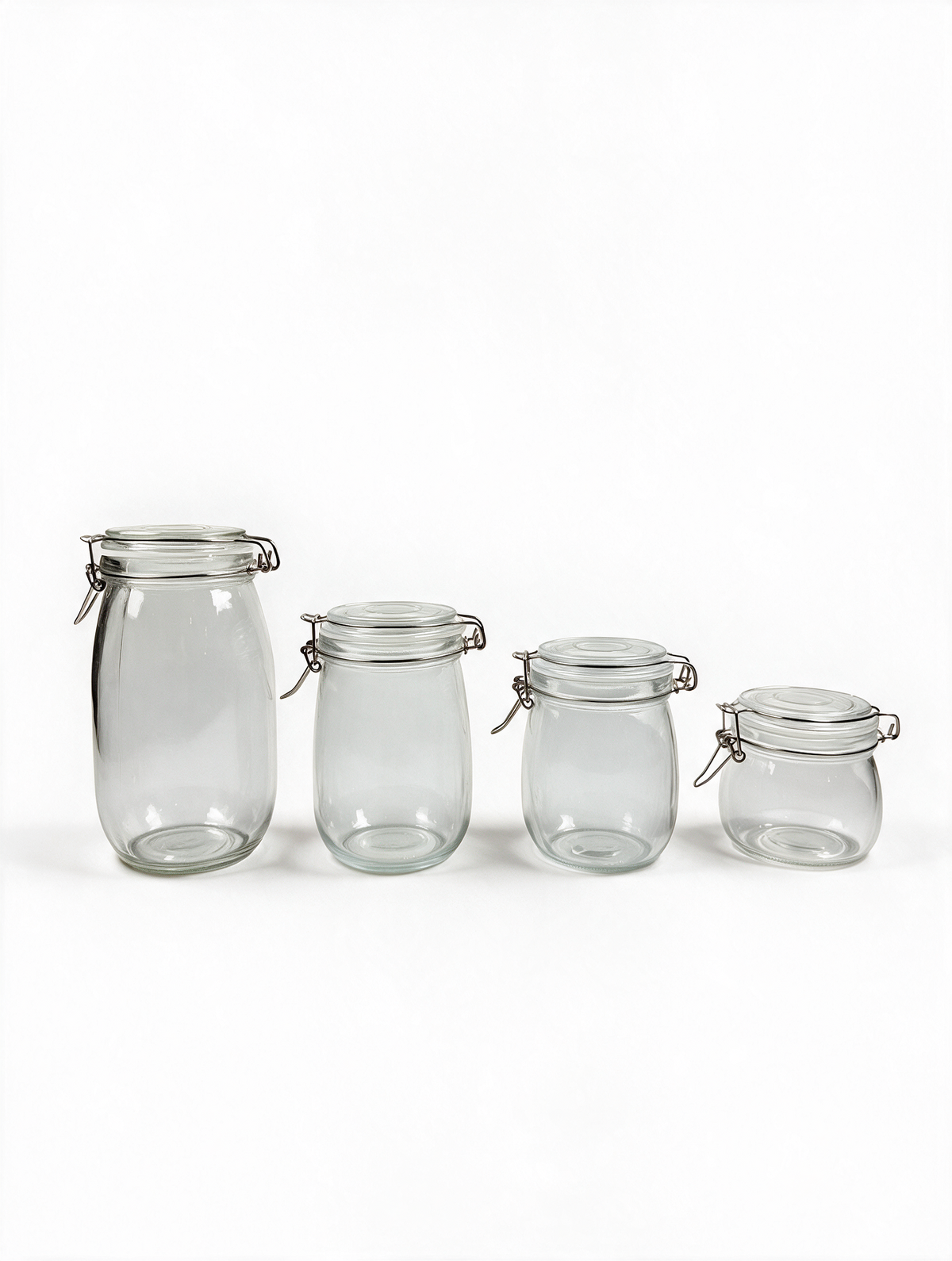 Clip-top glass storage jars in four sizes on a white background