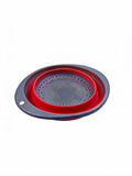 Collapsible silicone colander in red on white background