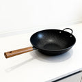 Vallena granite-coated fryer with a black speckled non-stick surface and a light wood-toned handle.