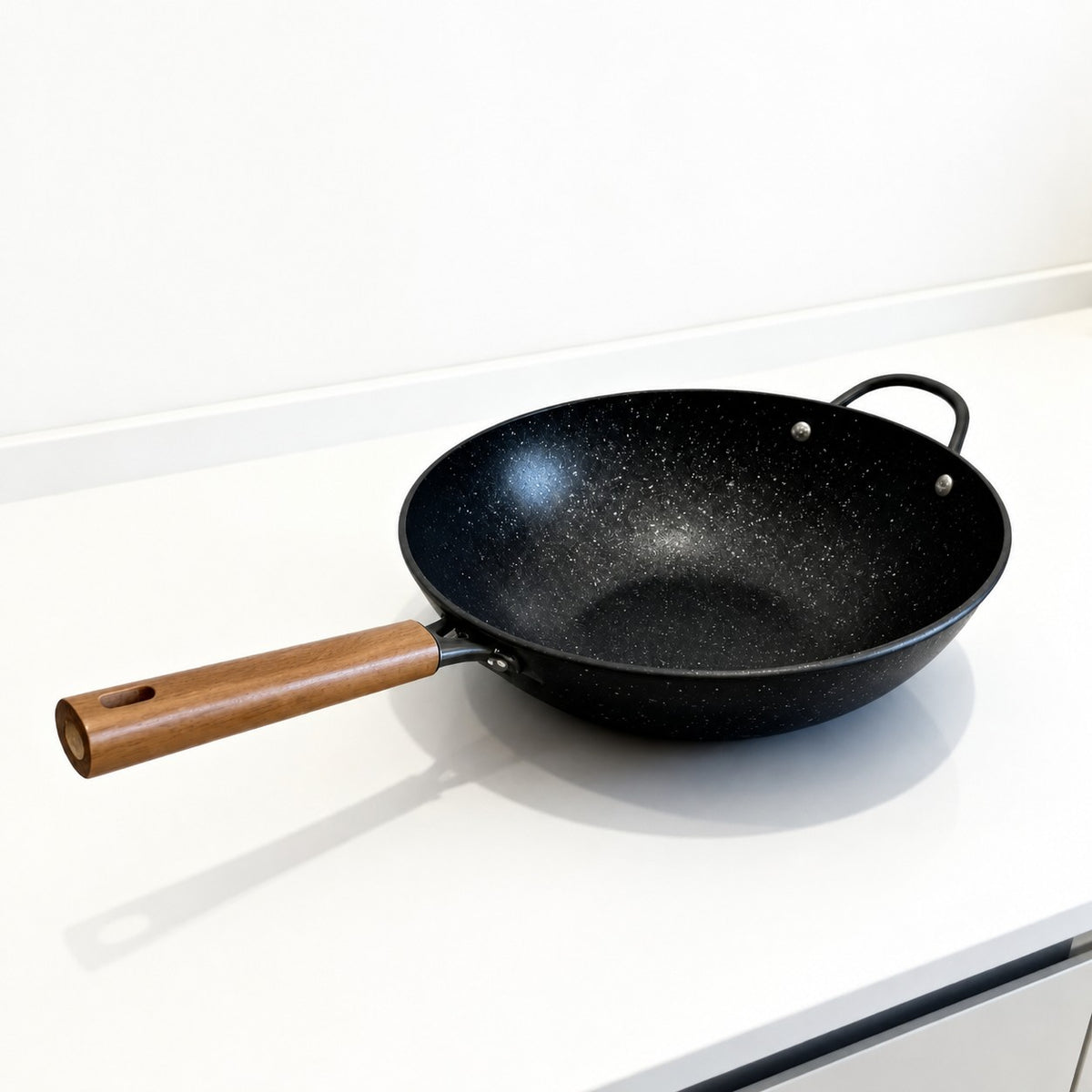 Vallena granite-coated fryer with a black speckled non-stick surface and a light wood-toned handle.
