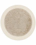Round furry area rug in beige on white background