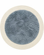 Round furry area rug in blue on white background