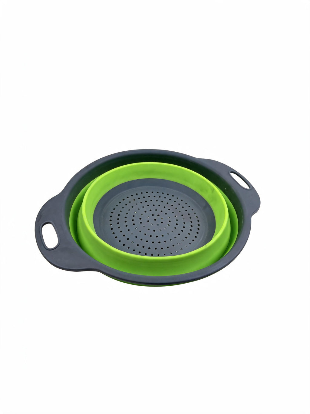 Small collapsible silicone colander in green collapsed on white background