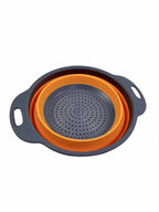 Small collapsible silicone colander in orange on white background