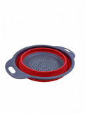 Small collapsible silicone colander in red on white background