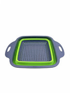 Small square collapsible colander in green on white background