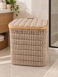 Square textured laundry basket with lid styled in a bathroom