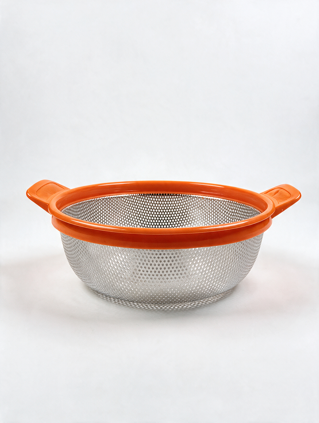 Stainless steel colander with orange handles and rim on white background
