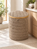 Textured round laundry basket with lid styled in a bathroom